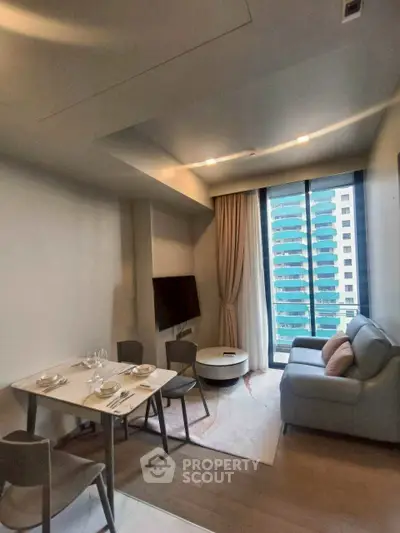 Modern living room with dining area and city view, featuring sleek furniture and large windows.