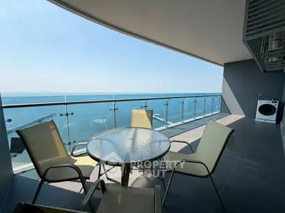 Stunning balcony with ocean view and modern outdoor seating, perfect for relaxation.