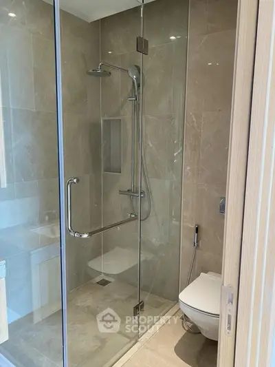Modern bathroom with glass shower enclosure and sleek fixtures