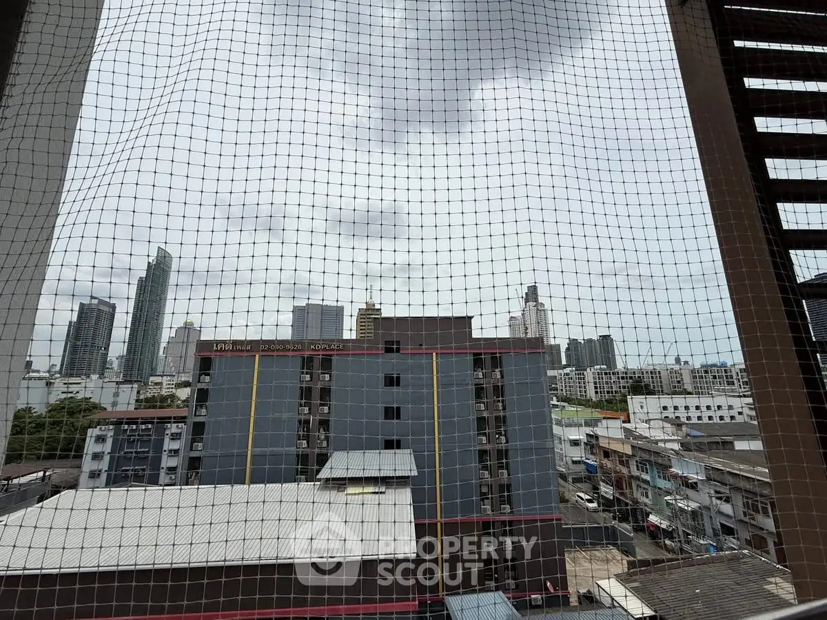 Urban cityscape view from high-rise building with safety netting