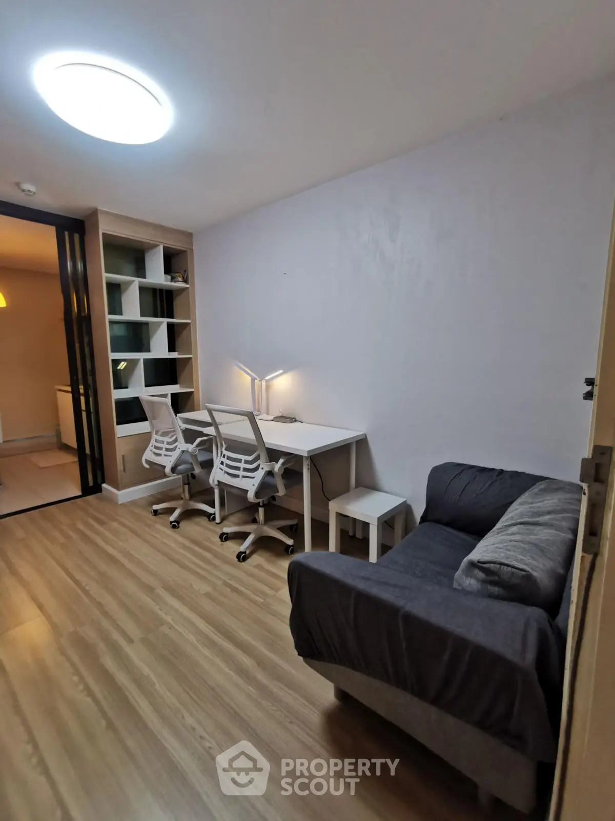 Modern study room with sleek desk and chairs, perfect for productivity.