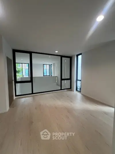 Spacious modern living room with large windows and sleek flooring