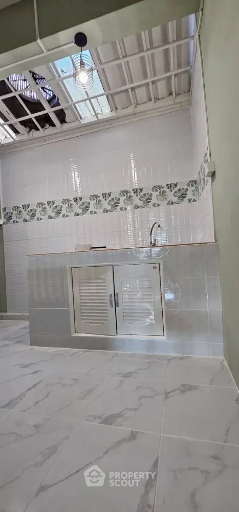 Modern kitchen with sleek tile design and compact layout