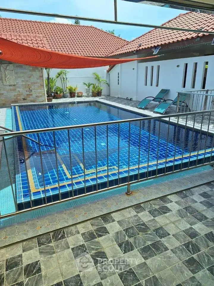 Stunning private pool area with modern design and sun loungers, perfect for relaxation.