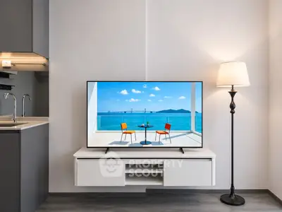 Modern living room with sleek TV setup and elegant floor lamp, showcasing minimalist design.