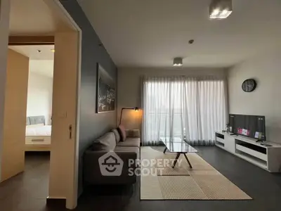 Modern living room with stylish decor and natural light near bedroom