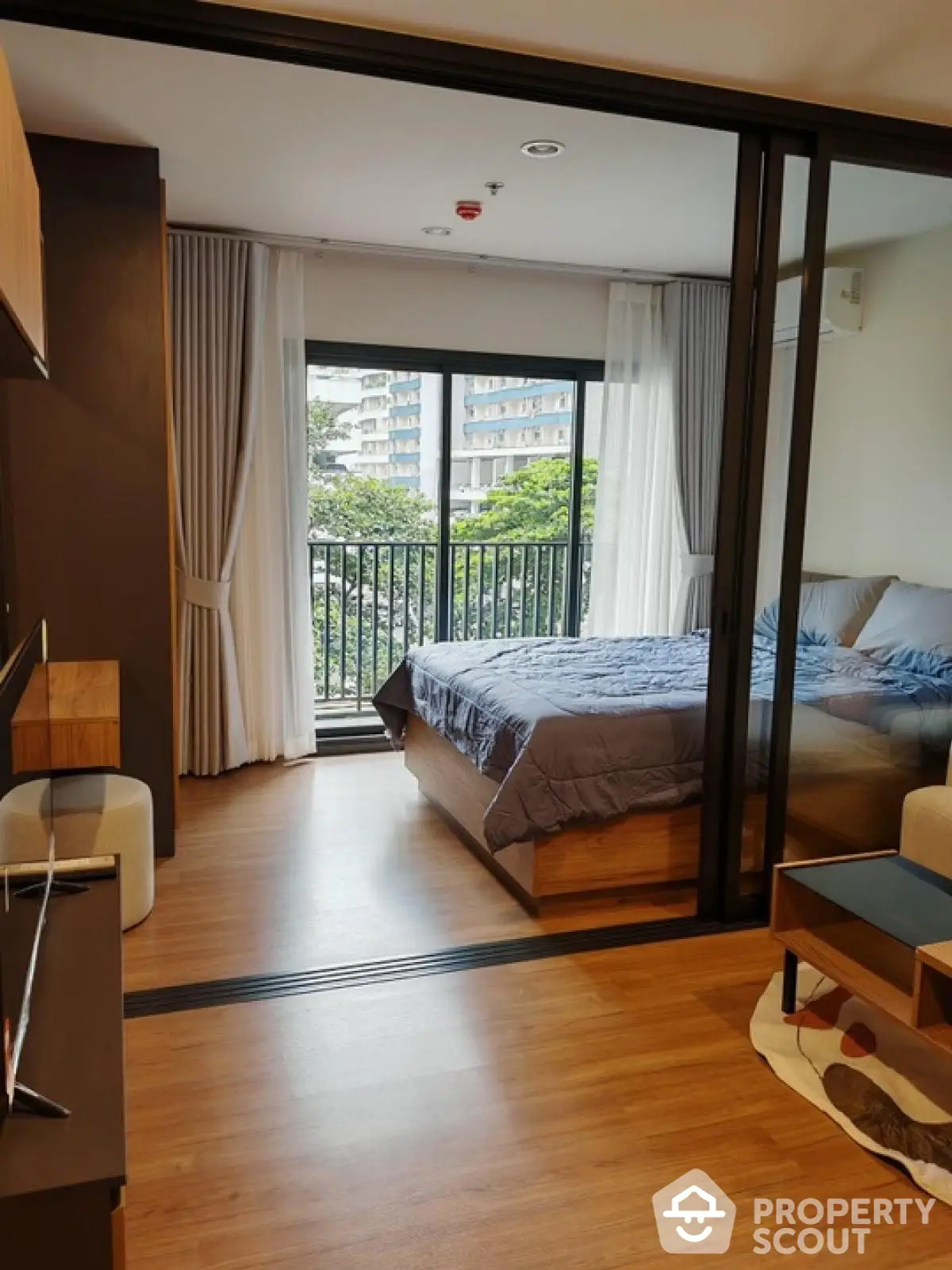 Modern bedroom with balcony view in urban apartment