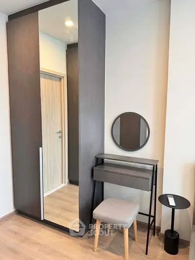 Modern bedroom corner with sleek wardrobe and stylish vanity set
