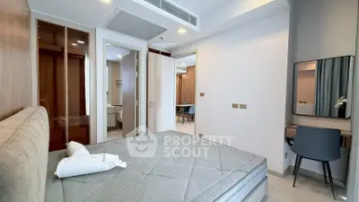 Modern bedroom with stylish decor and ensuite bathroom in a contemporary apartment.