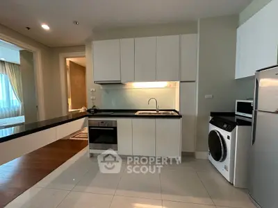 Modern kitchen with sleek cabinetry and built-in appliances in a stylish apartment.