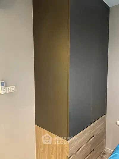 Modern bedroom with sleek built-in wardrobe and minimalist design.