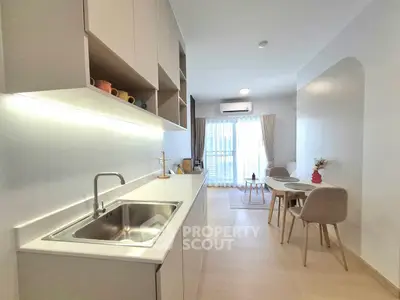 Modern open-layout kitchen and dining area with natural light and minimalist design.