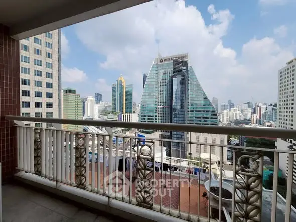 Stunning cityscape view from a spacious balcony in a high-rise building.