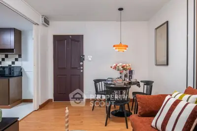 Charming living room with cozy dining area and modern kitchen in open layout apartment.
