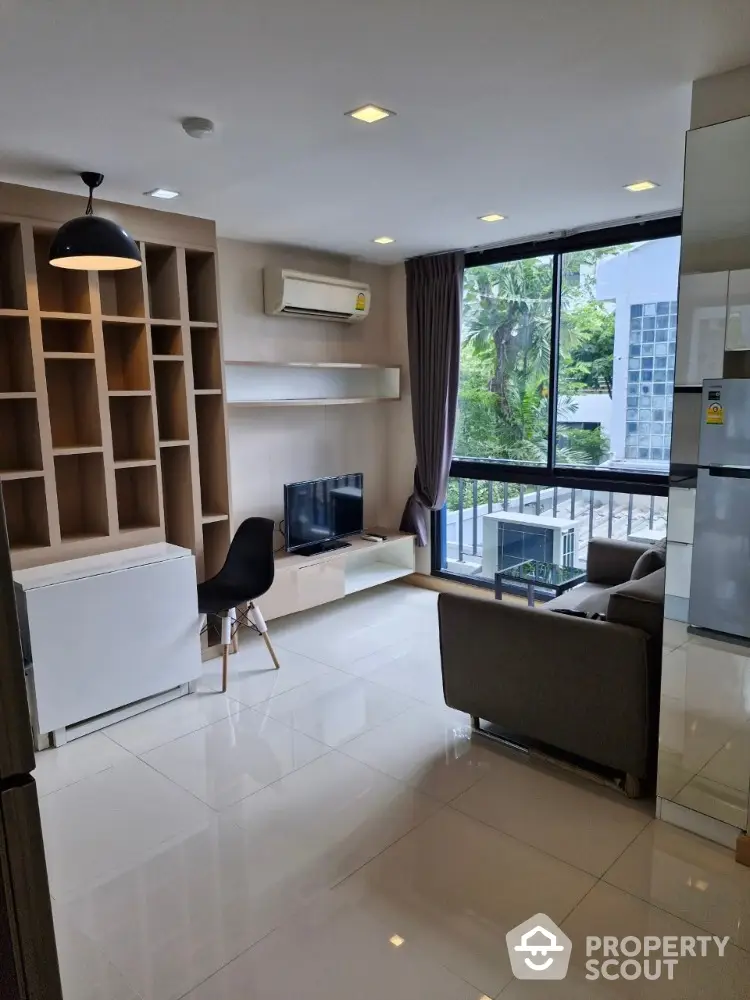 Modern living room with large window and built-in shelving unit