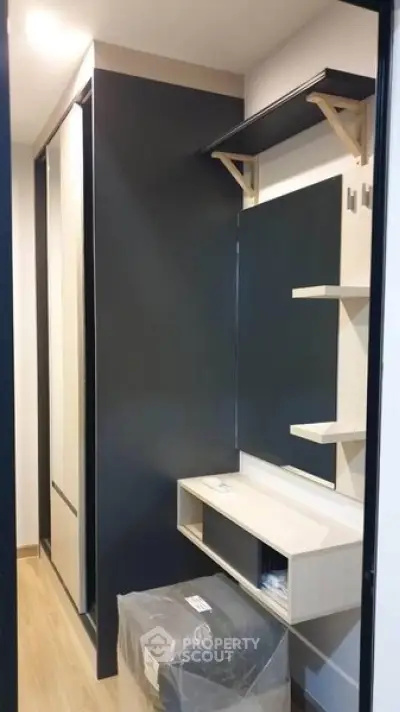 Modern storage area with sleek design and ample shelving in a contemporary apartment.