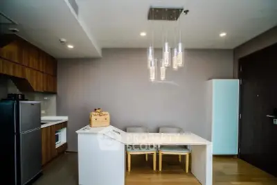 Modern kitchen with sleek design and stylish lighting in a contemporary apartment.