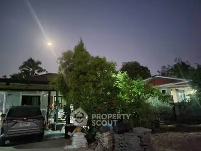 Charming suburban home with lush garden and driveway under moonlit sky, perfect for serene living.