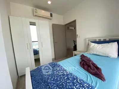 Cozy bedroom with modern decor and air conditioning in a stylish apartment.