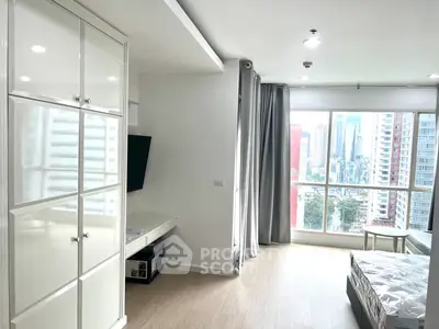 Modern bedroom with city view and sleek furnishings in high-rise apartment