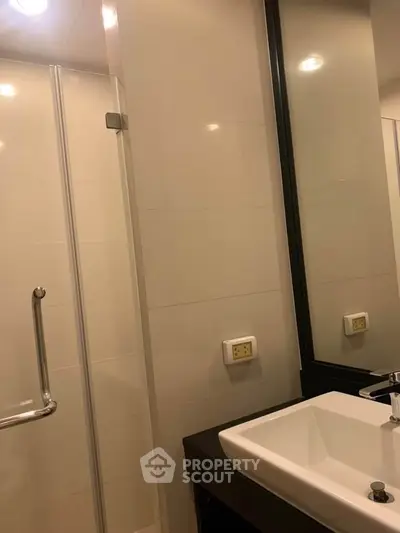 Modern bathroom with sleek sink and glass shower enclosure