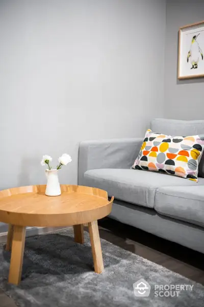 Modern living room with stylish gray sofa and wooden coffee table