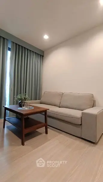 Cozy living room with modern sofa and wooden coffee table, perfect for relaxation.