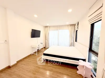 Bright and spacious bedroom with large windows and modern decor