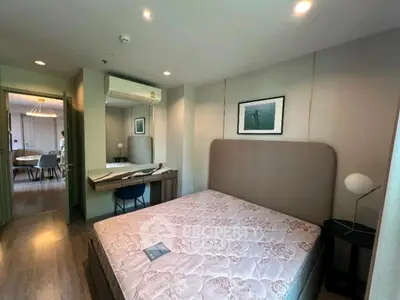 Modern bedroom with stylish decor and natural light, featuring a comfortable bed and elegant furnishings.