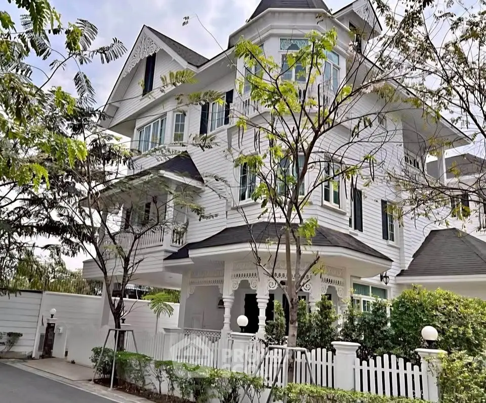 Stunning Victorian-style white house with intricate detailing and lush greenery, perfect for luxurious living.