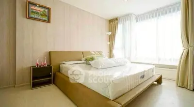 Spacious bedroom with large windows and elegant decor