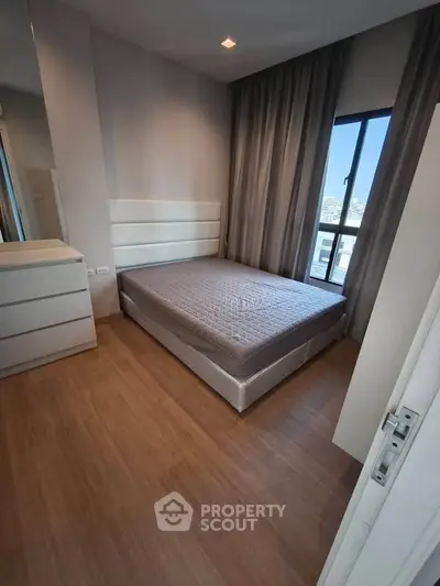 Modern bedroom with large window and minimalist design in urban apartment