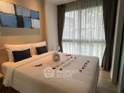 Elegant bedroom with large window and stylish decor, perfect for relaxation and comfort.