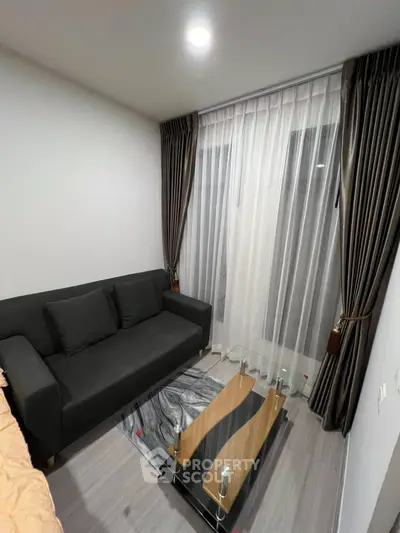 Cozy living room with modern sofa and stylish curtains, perfect for relaxation.