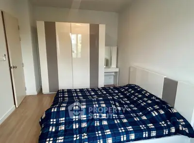 Cozy bedroom with modern wardrobe and stylish bedding