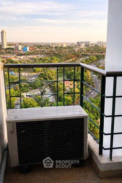 High-rise balcony with cityscape view and air conditioning unit