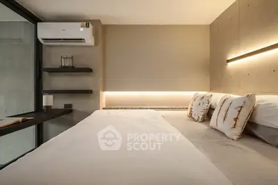 Modern bedroom with sleek design, featuring ambient lighting and air conditioning for ultimate comfort.
