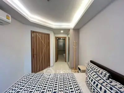 Modern bedroom with stylish ceiling lights and patterned bedding