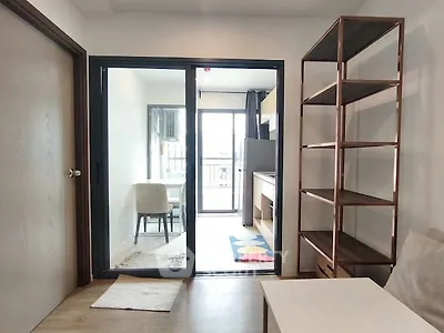 Modern apartment interior with open layout and stylish shelving unit.