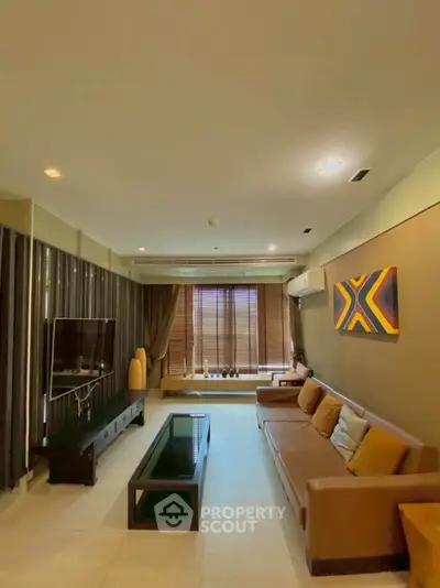 Spacious modern living room with stylish decor and large windows for natural light.