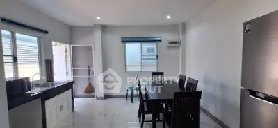 Modern kitchen and dining area with sleek design and natural light