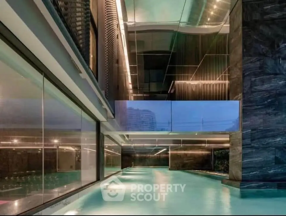 Luxurious indoor pool with modern architectural design and ambient lighting
