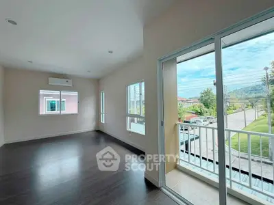 Spacious living room with balcony and scenic view in modern home