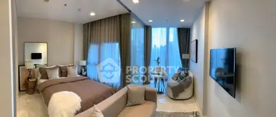 Luxurious modern bedroom with cozy seating area and large windows