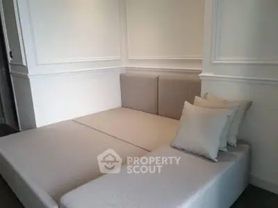 Elegant modern living room with stylish beige sectional sofa and decorative wall panels.