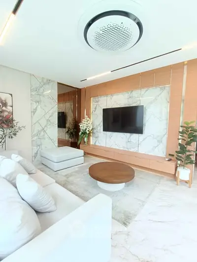 Luxurious modern living room with marble accents and sleek furniture design.