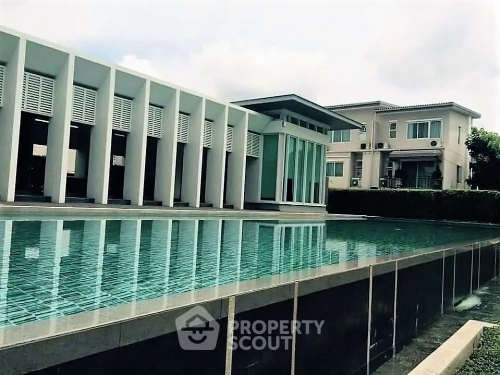 Modern architectural building with sleek pool reflecting contemporary design elegance.