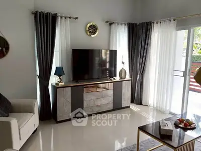 Modern living room with sleek TV stand, elegant curtains, and stylish decor