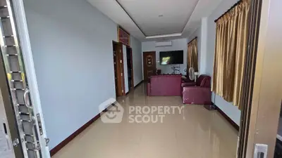 Spacious living room with modern furniture and large windows for natural light.