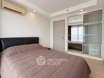 Modern bedroom with air conditioning and sliding closet doors in a stylish apartment.